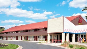A two-story motel with a red roof and a 'Red Roof Plus' sign. - Red Roof Inn PLUS+ Ann Arbor - U of Michigan North (Ann Arbor)