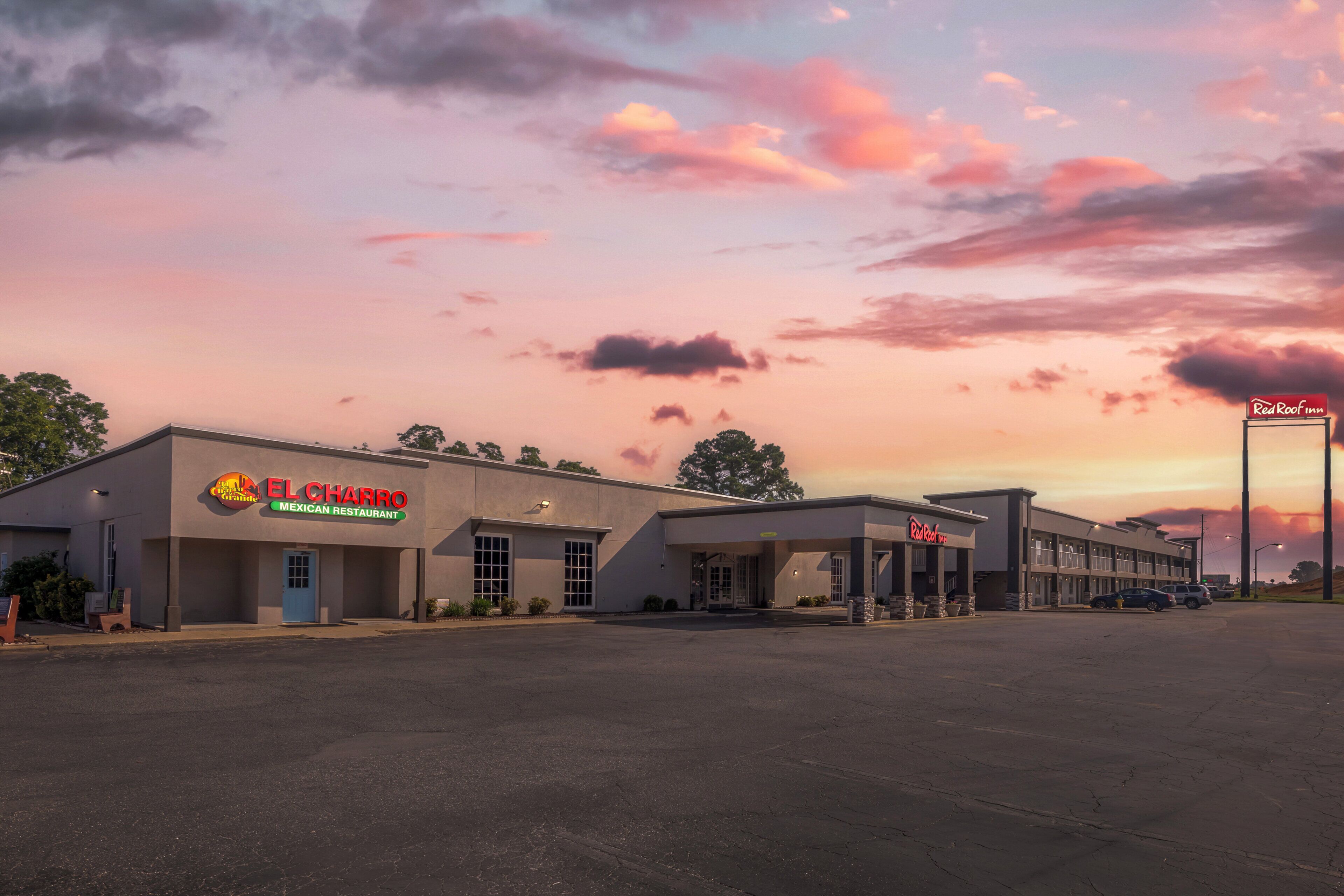 A commercial building with a Red Roof Inn sign, El Charro Mexican Restaurant, and a parking lot.