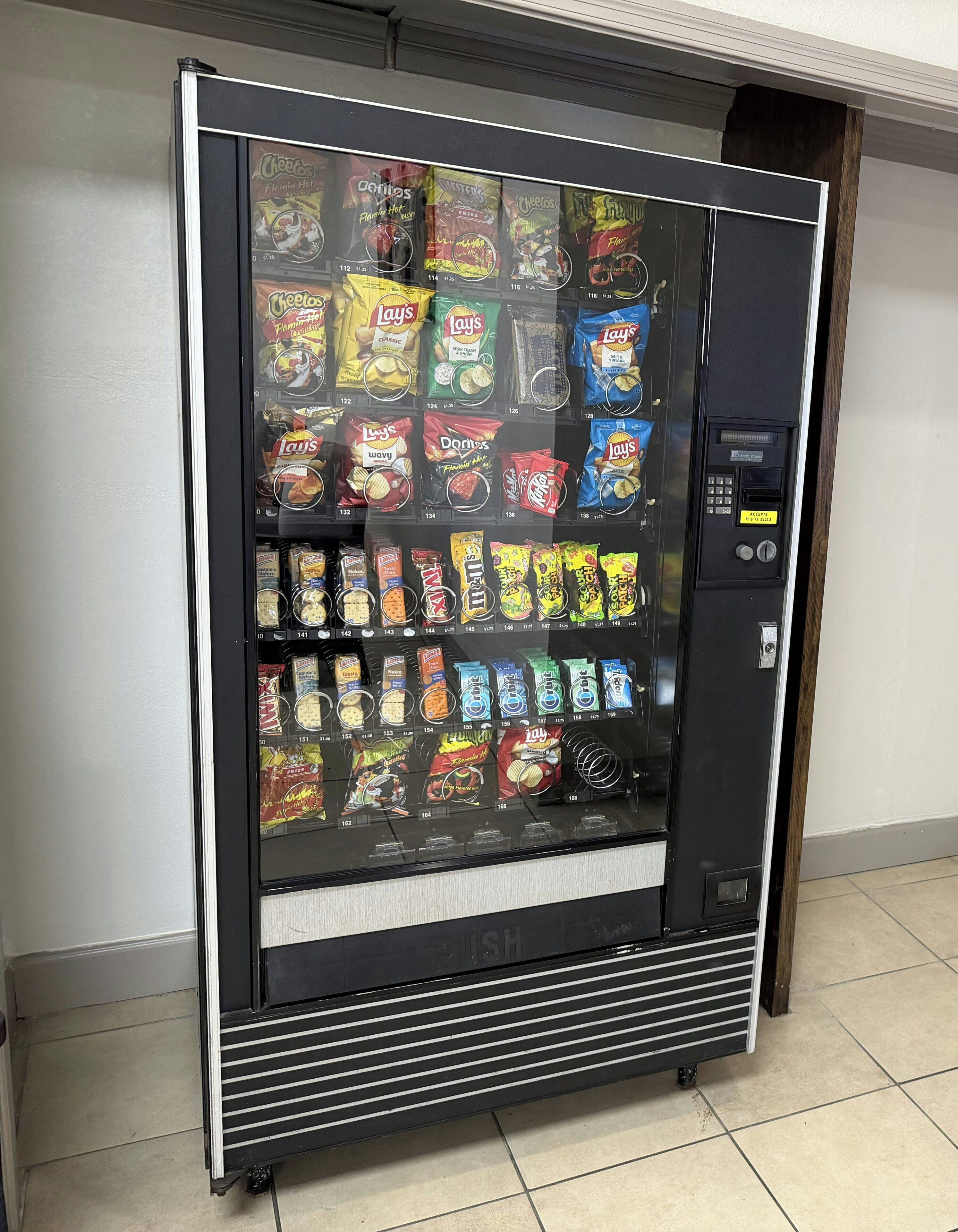 A vending machine stocked with various snacks.