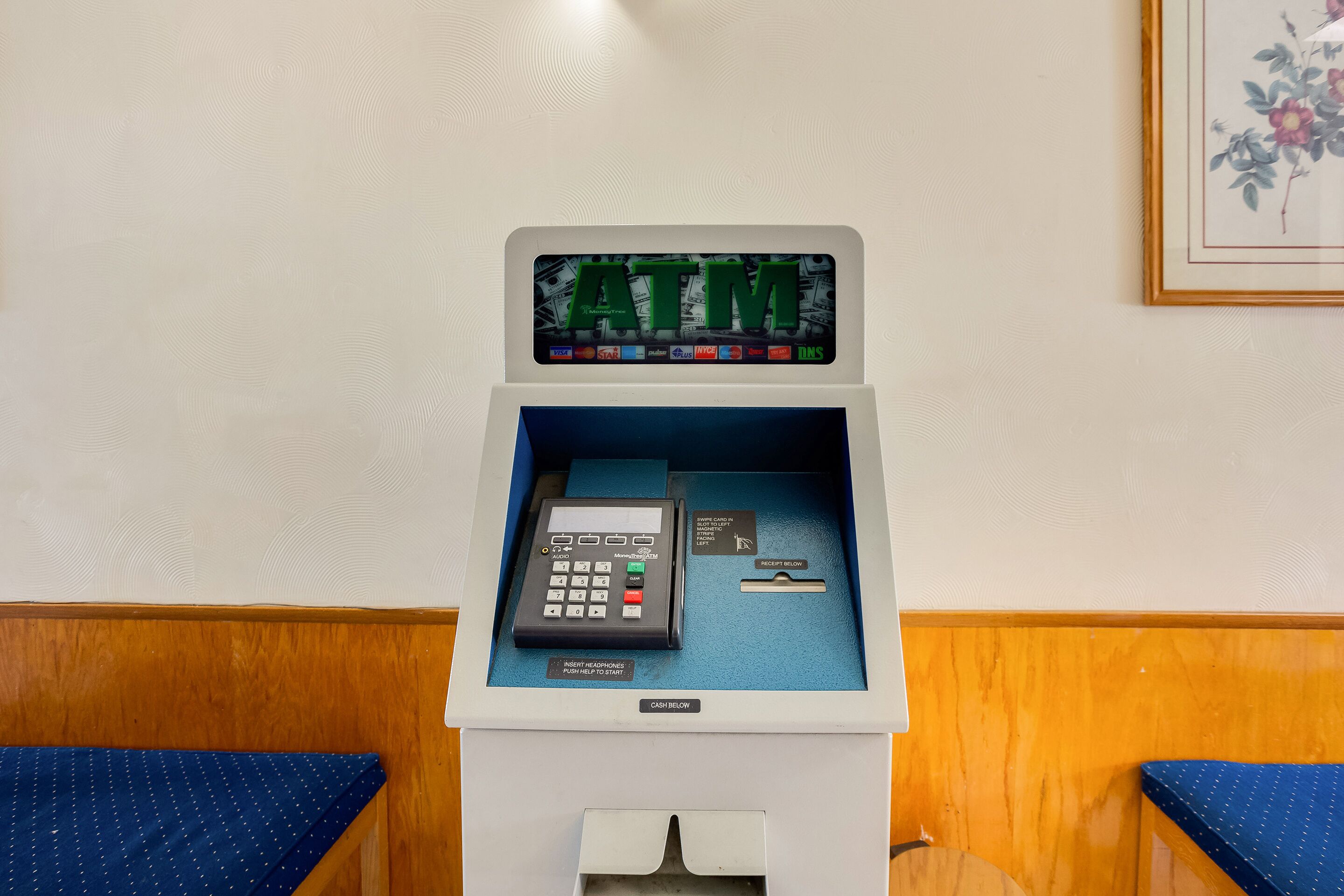 An ATM machine with a digital display, a keypad, and a card slot.