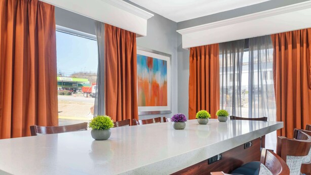A conference room with a long table, chairs, and potted plants. - Best Western Royal Inn (Chattanooga)