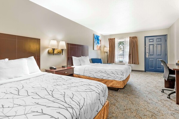 A hotel room with two beds, a desk, a chair, and a door. - Best Western Royal Inn (Chattanooga)