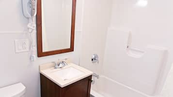 Bathtub, eco-friendly toiletries, hair dryer, towels