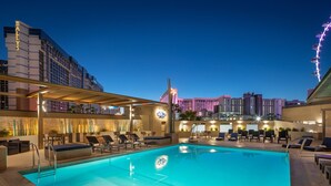 A rooftop pool with lounge chairs and a view of the city skyline at dusk. - The Westin Las Vegas Hotel & Spa (Las Vegas)