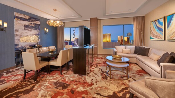 A modern hotel room with a dining area, a sofa, and a large window with a city view. - The Westin Las Vegas Hotel & Spa (Las Vegas)