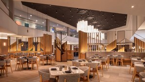 A modern restaurant with multiple dining areas, wooden accents, and a contemporary ceiling design. - The Westin Las Vegas Hotel & Spa (Las Vegas)