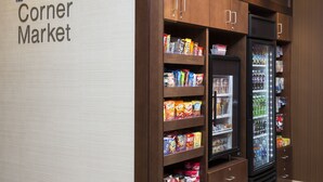 A Corner Market with shelves stocked with snacks and a refrigerated section. - Fairfield Inn & Suites Galesburg (Galesburg)