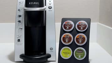 A Keurig coffee maker with a coffee pod holder displaying various coffee pods.
