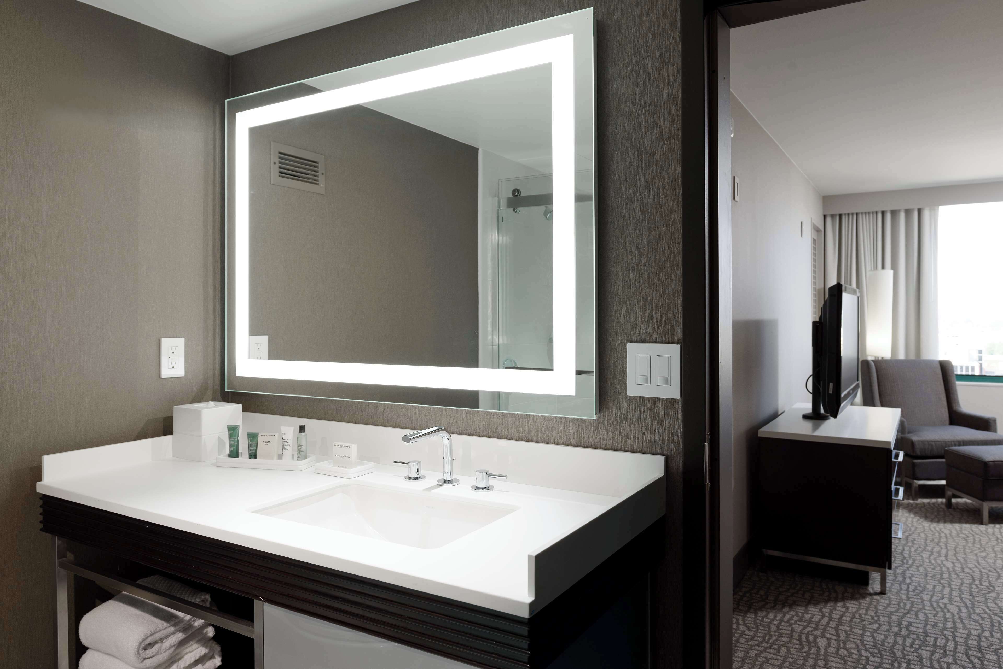 designer toiletries, hair dryer, towels