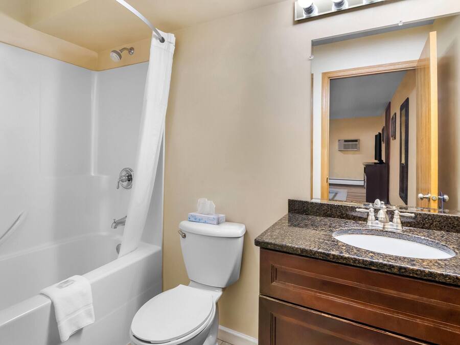 A bathroom with a bathtub, toilet, and sink.