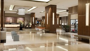 A spacious lobby with a reception desk, seating area, and a large chandelier. - Renaissance Dallas Addison Hotel (Addison)