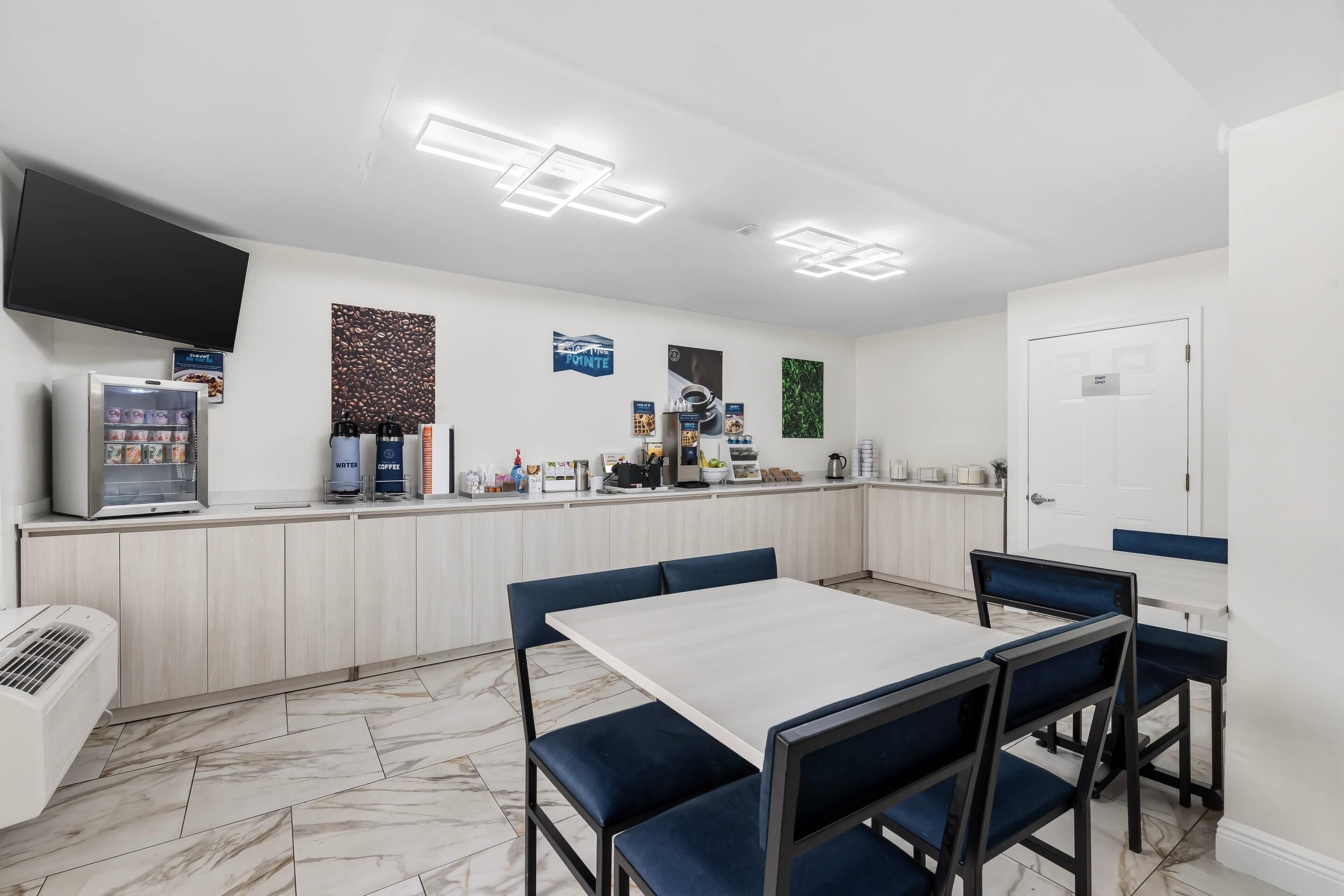 A modern cafe with a counter, coffee machines, and seating.