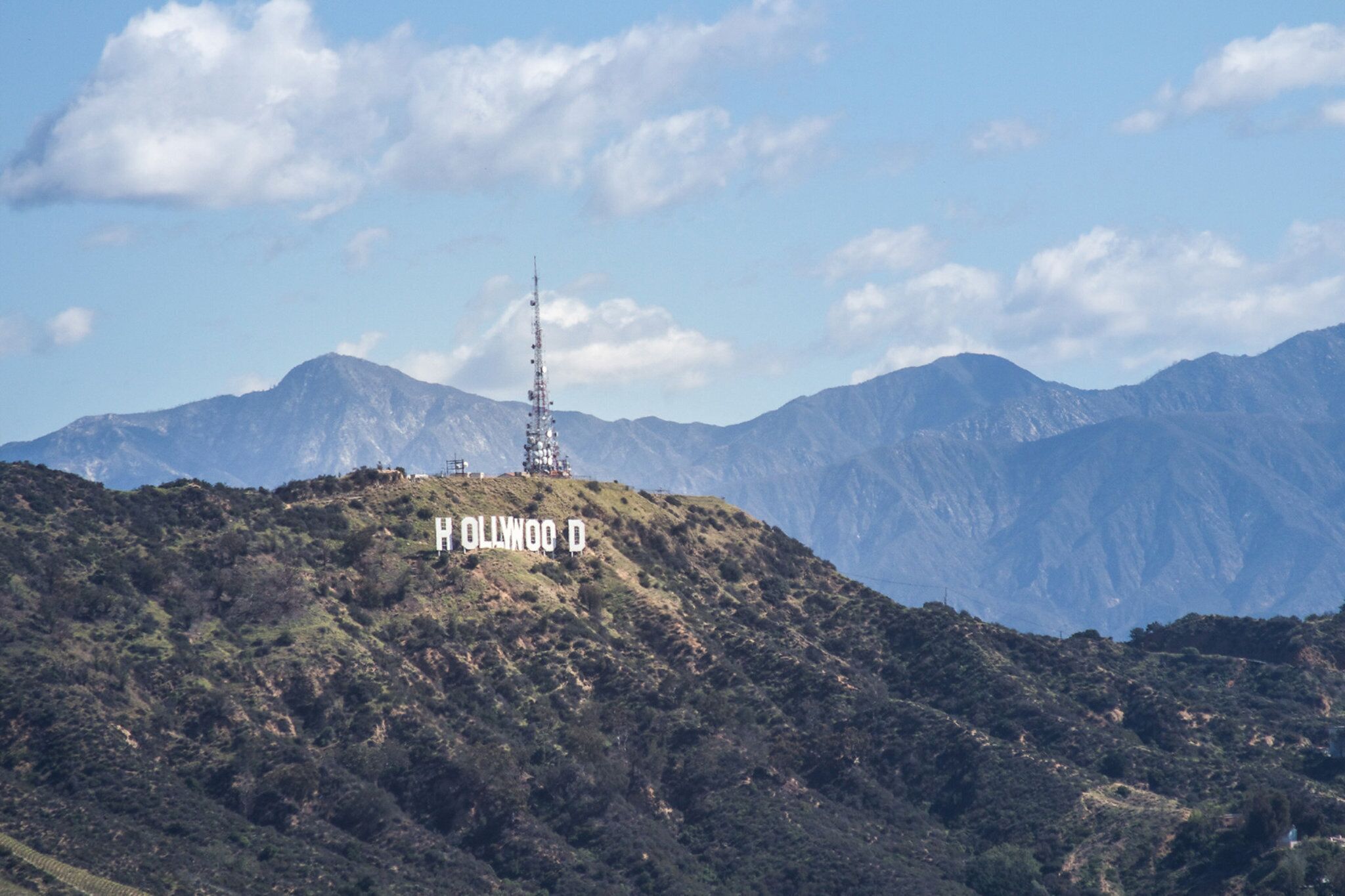 A mountainous landscape with a prominent tower labeled "OLIWWOOD D" on a hill.
