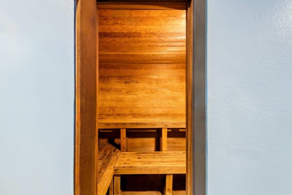 A wooden bench with a slatted design, likely part of a room's interior.