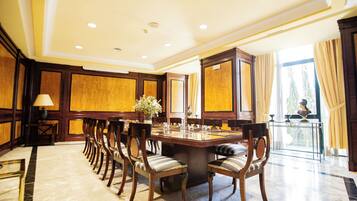 A conference room with a long table, chairs, and a decorative vase.