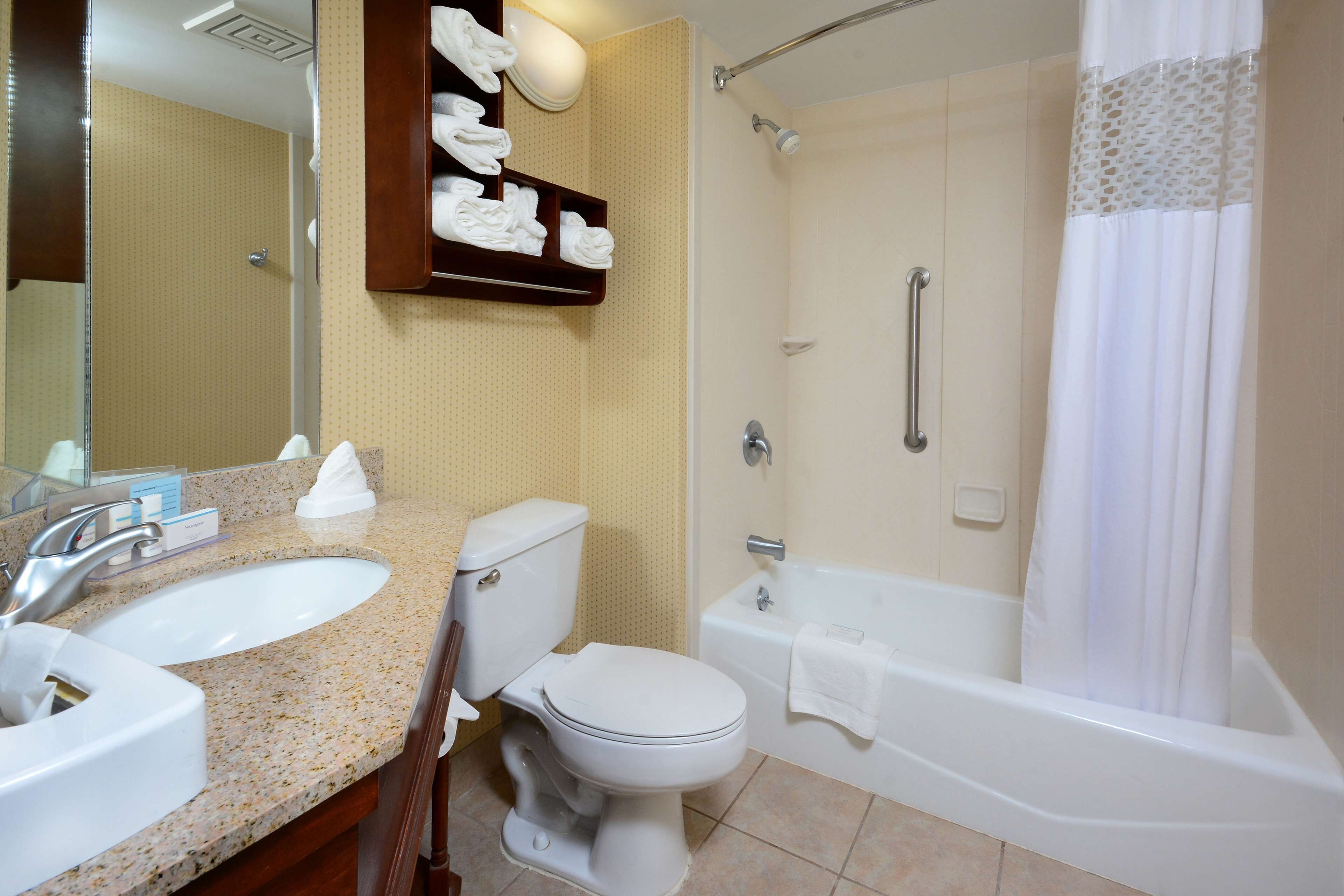 A bathroom with a sink, toilet, and bathtub.