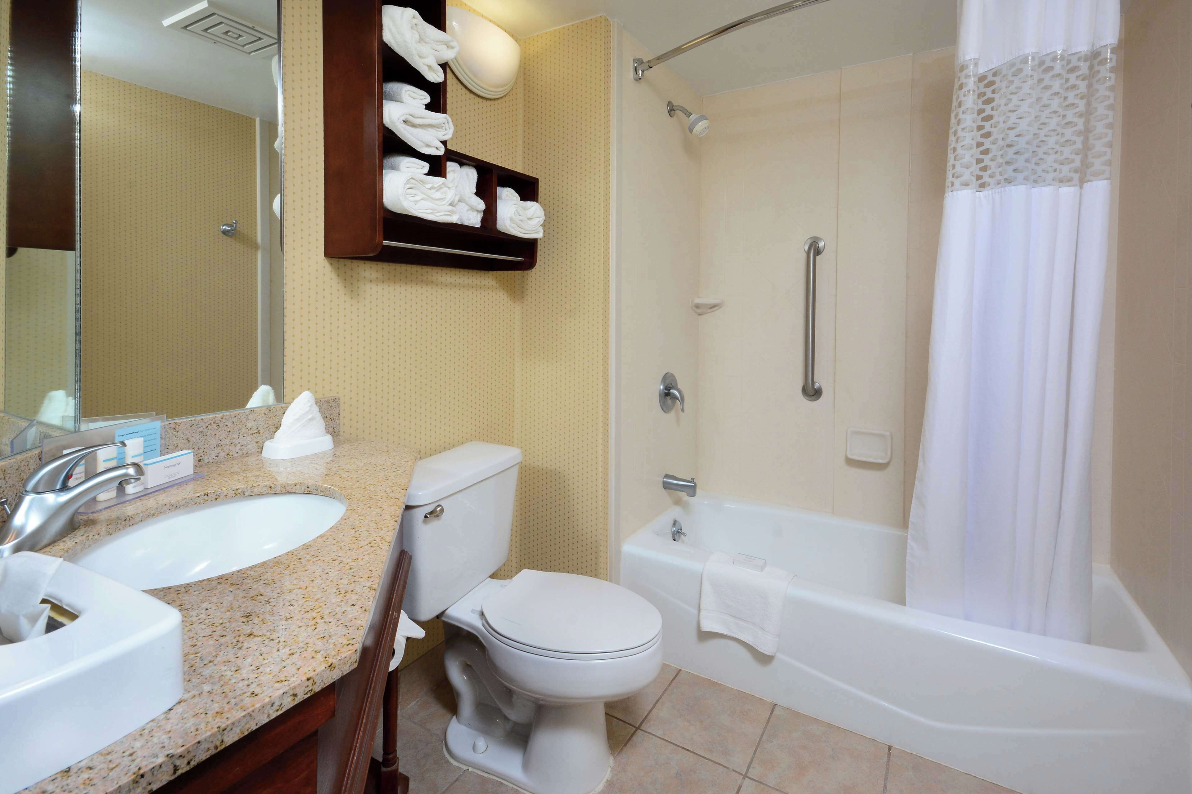 A bathroom with a sink, toilet, bathtub, and shower.
