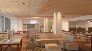 A modern hotel lobby with a central seating area, multiple tables, and a large window providing natural light. - Holiday Inn Alexandria at Carlyle by IHG (Alexandria)