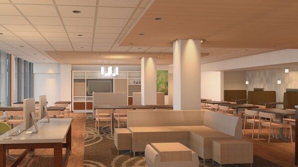 A modern hotel lobby with a central seating area, multiple tables, and a large window providing natural light. - Holiday Inn Alexandria at Carlyle by IHG (Alexandria)