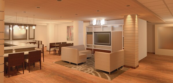 Un moderno vestíbulo de hotel con zona de comedor, asientos y televisor.