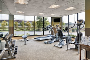 A gym with treadmills, elliptical machines, and dumbbells. - Holiday Inn Alexandria at Carlyle by IHG (Alexandria)