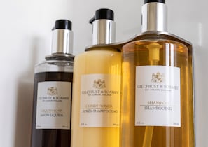Three Gilchrist & Soames shampoo bottles.