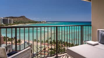 A balcony with a view of a beach and ocean.