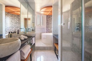 A modern bathroom with a large sink, a bathtub, and a glass shower enclosure. - Hotel Montalembert (Paris)