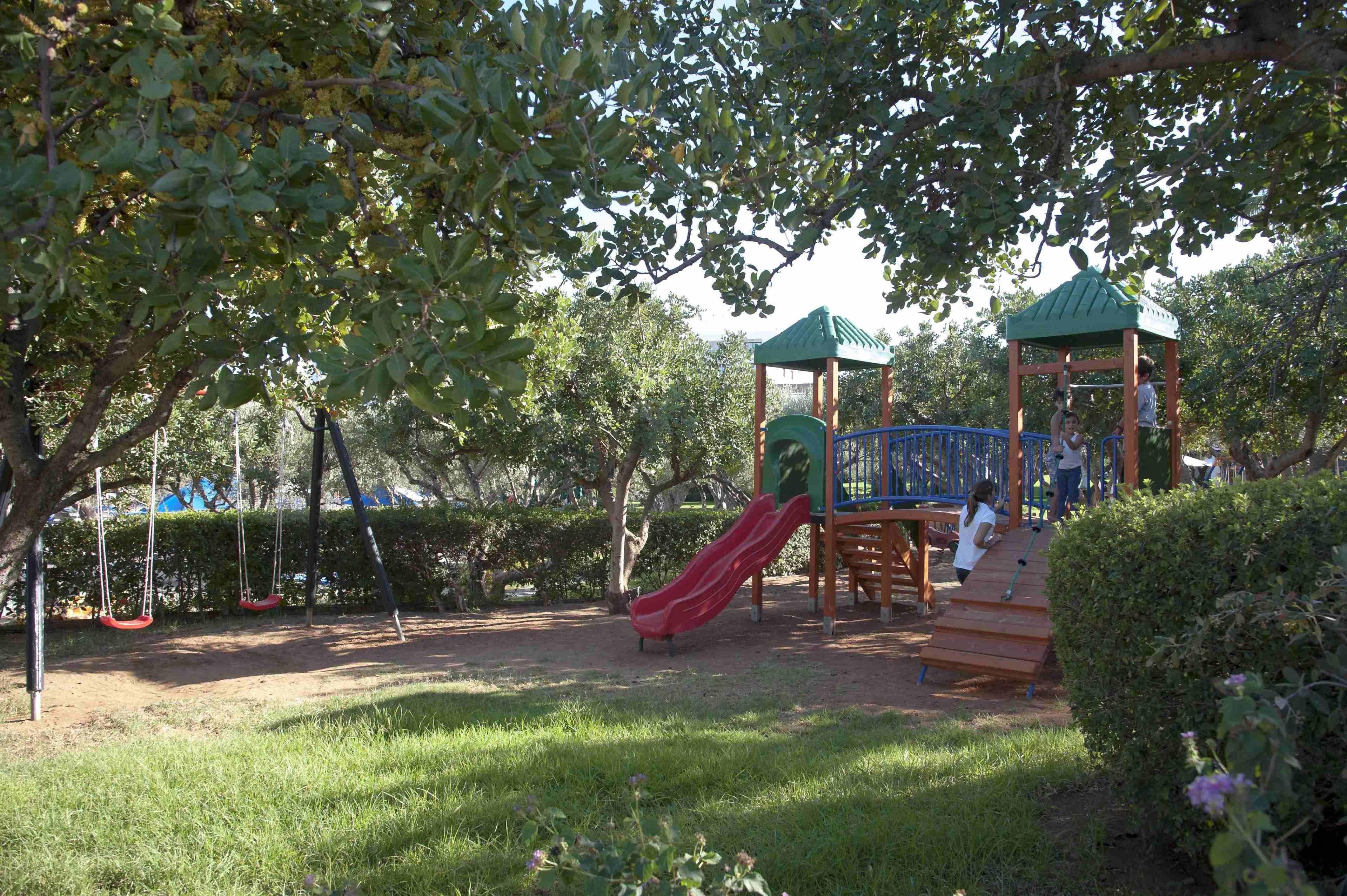 A playground with swings, a slide, and a climbing structure.