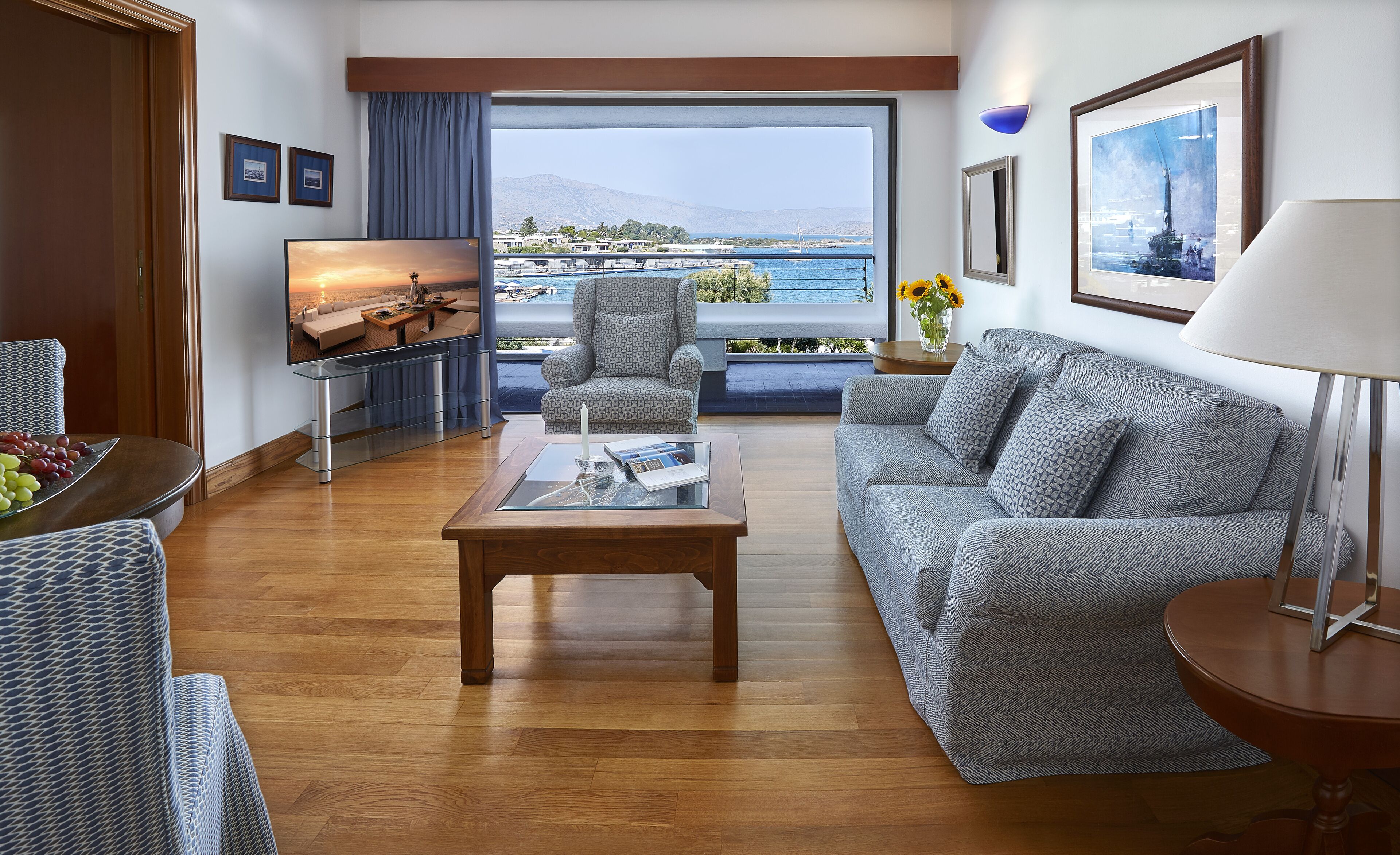 deluxe hotel or bungalow suite sea view (one bedroom & sitting room separate or in open plan style) | living area | flat-screen tv, ping pong, books