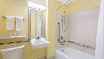 A bathroom with a toilet, sink, mirror, towel rack, shower, and bathtub.