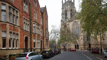 A street view with a historic building labeled "DEAN COURT" and a large Gothic cathedral in the background.