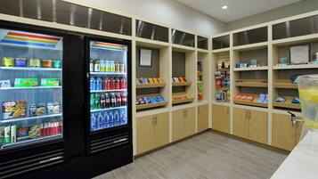 A clean, well-organized snack and drink vending area with various options including beverages, snacks, and ice cream.