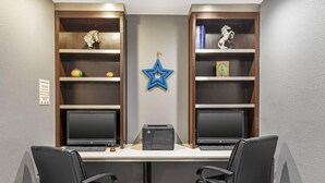A conference room with two desks, each with a computer and a printer. Shelves on either side hold decorative items. - Quality Inn & Suites Plano East - Richardson (Plano)