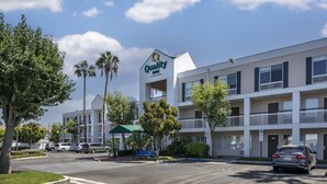 A multi-story hotel with a sign reading "Quality Inn." - Quality Inn Placentia Anaheim Fullerton (Placentia)