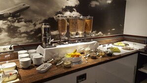 A buffet setup with various food items and a coffee station. - ibis Styles Cologne Airport Troisdorf (Troisdorf)