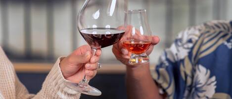 Two people holding wine glasses.
