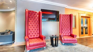 Relax in the stylish lobby with a comfortable seating area, flat-screen TV, and a bar.