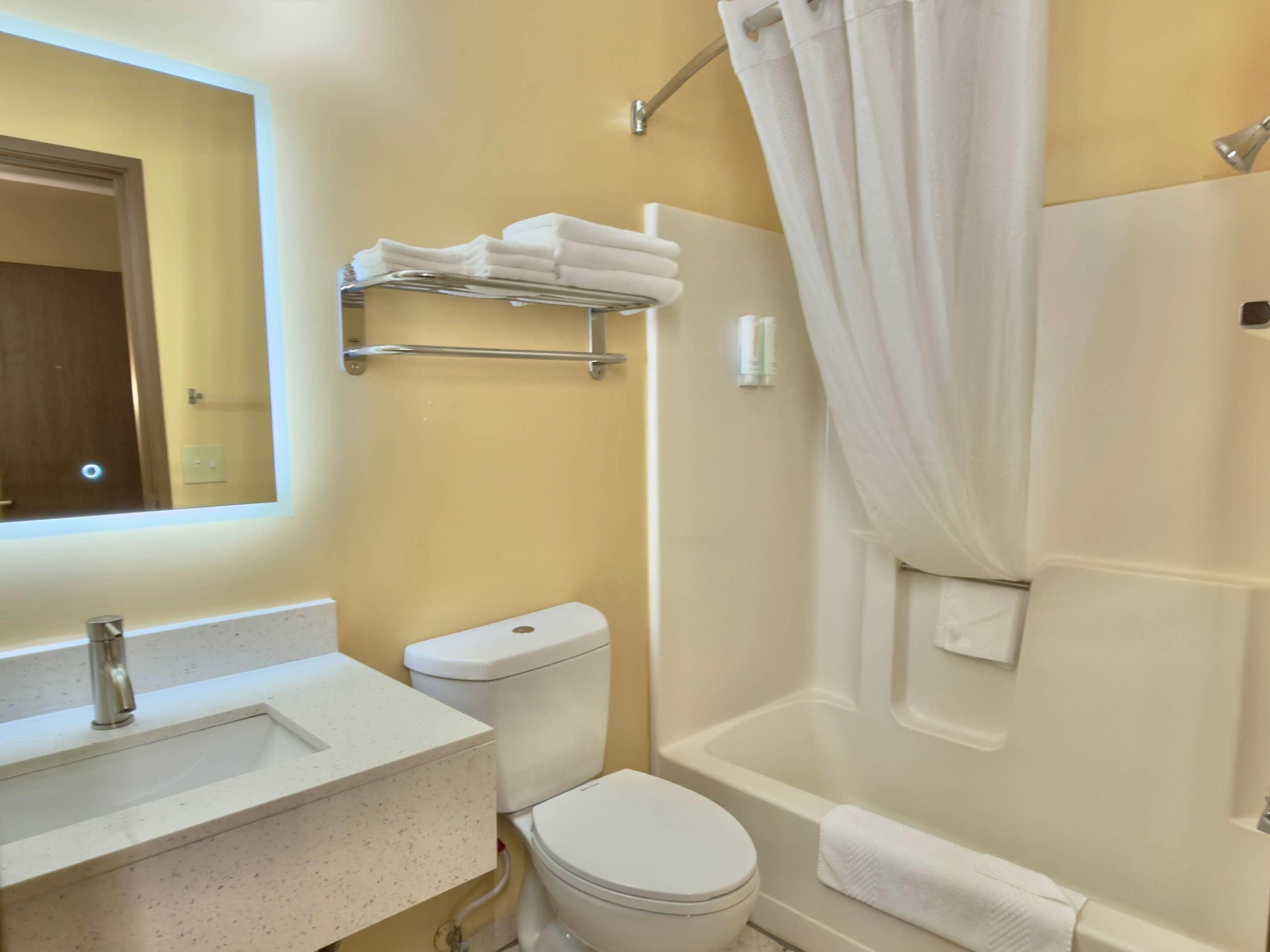 A bathroom with a sink, toilet, and bathtub.
