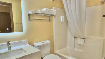 A bathroom with a sink, toilet, and bathtub.