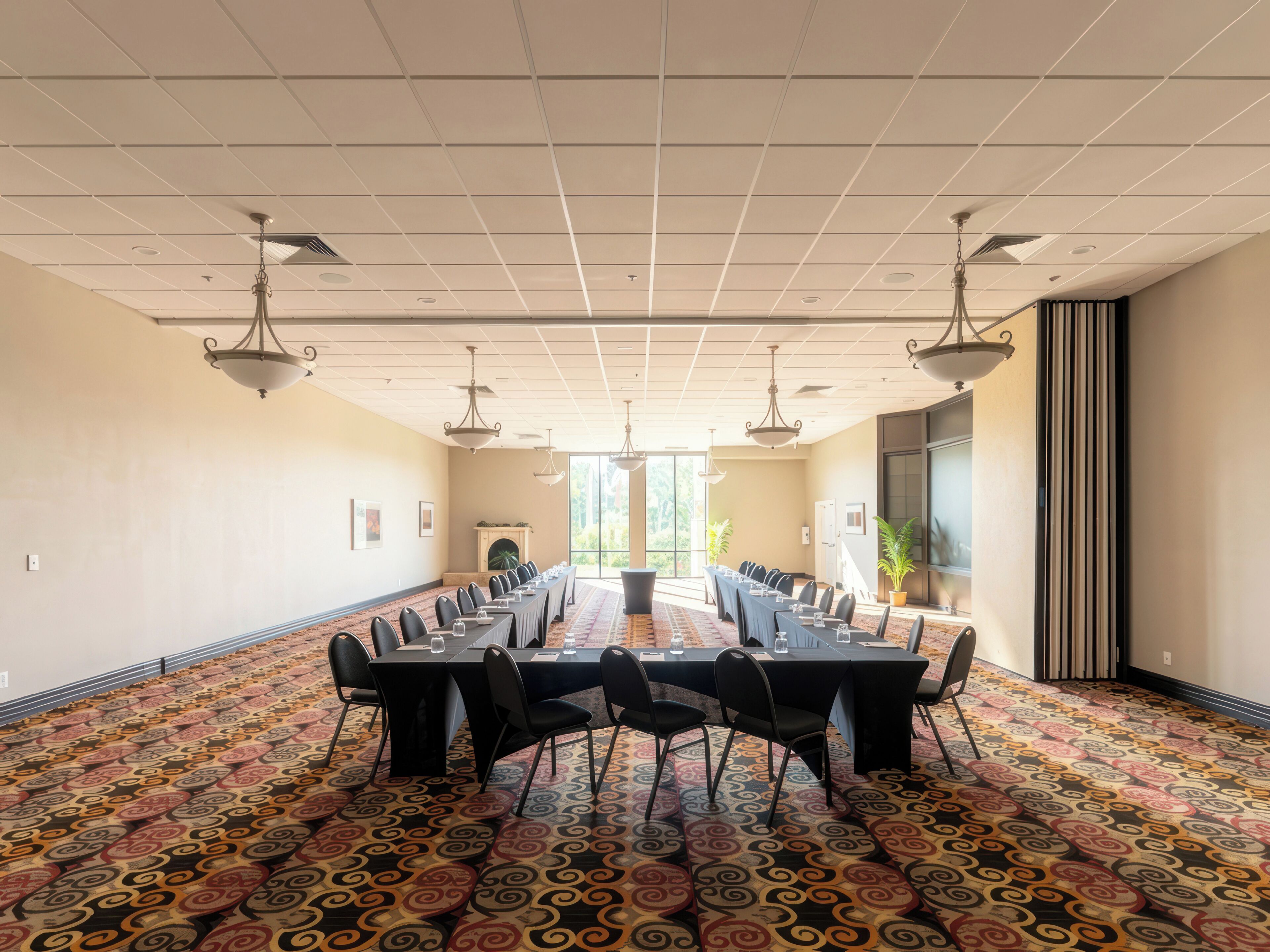 A conference room with a long table, chairs, and ceiling lights.
