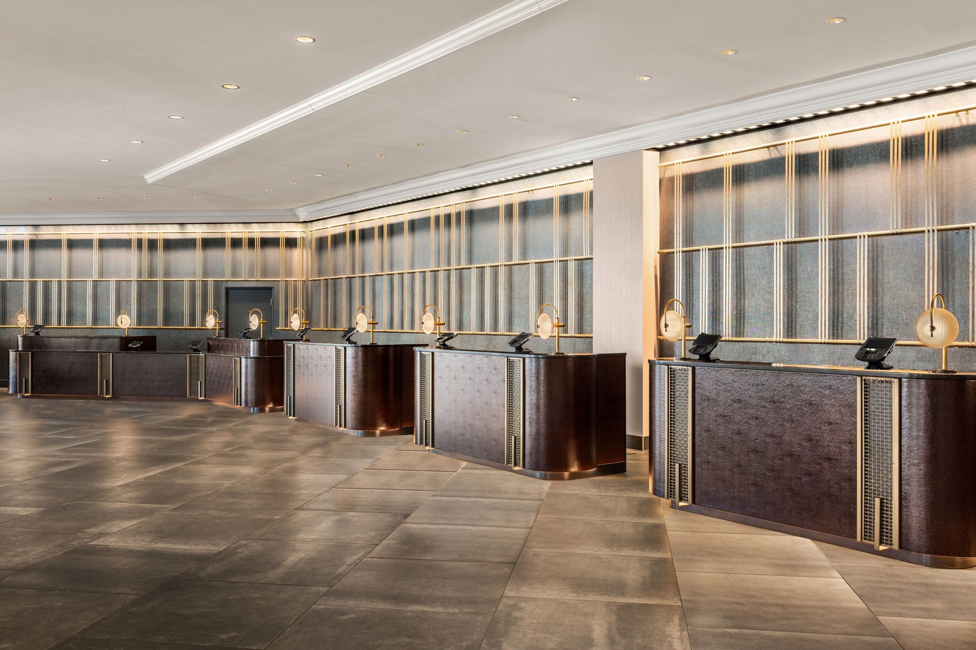A reception area with a long counter, multiple receptionists' stations, and a modern design.