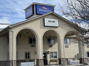 A building with a 'Baymont' sign and a 'Welcome' sign. - Baymont by Wyndham Bozeman (Bozeman)