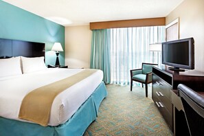 A hotel room with a large bed, a desk with a television, and a chair. -  Holiday Inn Express & Suites Charleston DWTN - Medical CTR by IHG (Charleston)