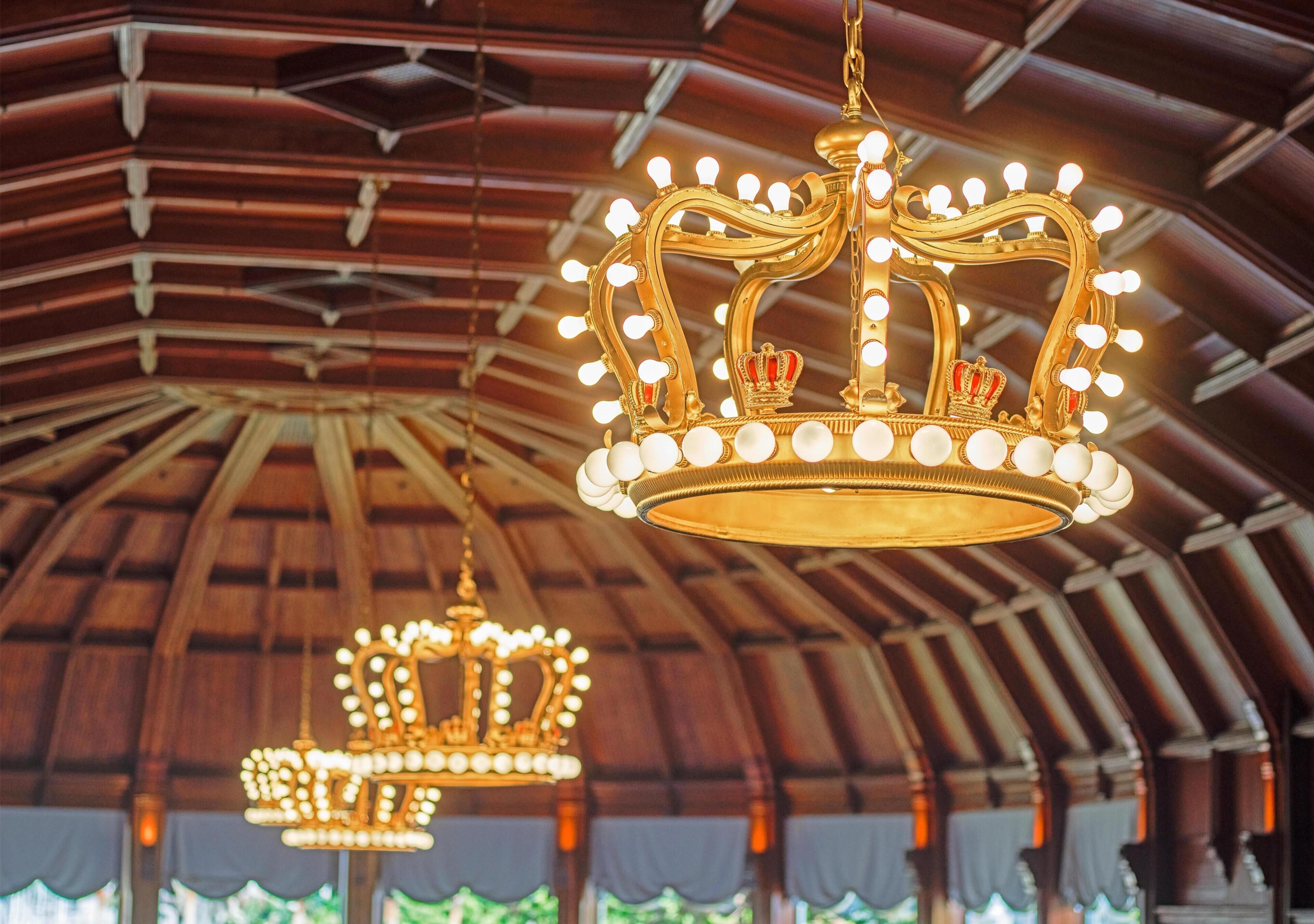 Un salón imponente con candelabros ornamentados y un techo alto y abovedado.