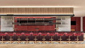 A bar area with multiple stools and a wine display.