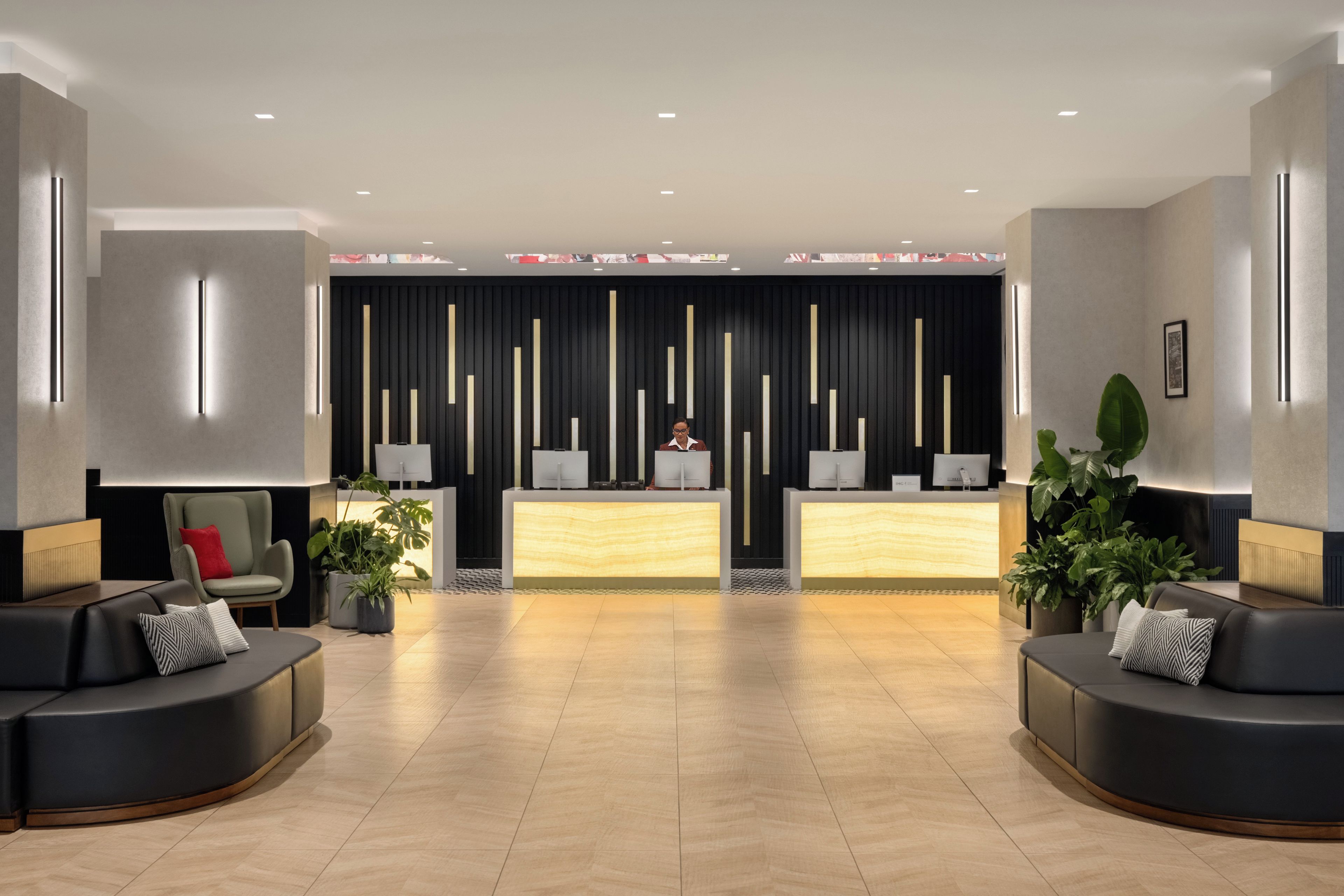 A modern reception area with a reception desk, seating, and decorative elements.