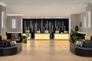 A modern reception area with a reception desk, seating, and decorative elements. - Crowne Plaza Manhattan Times Square by IHG (New York)