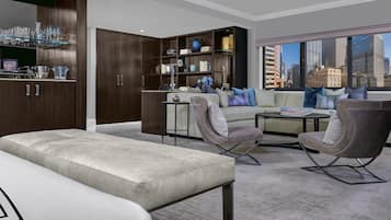 A modern living room with a sofa set, a coffee table, and a bookshelf.