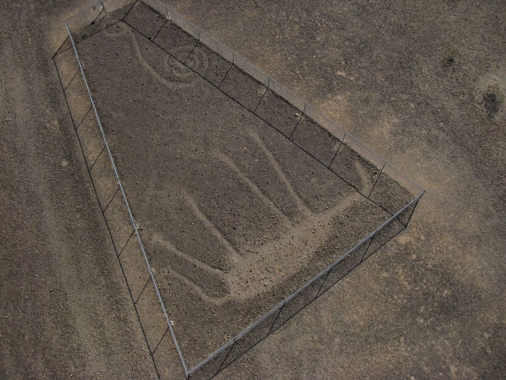 A rectangular concrete structure with metal reinforcements.